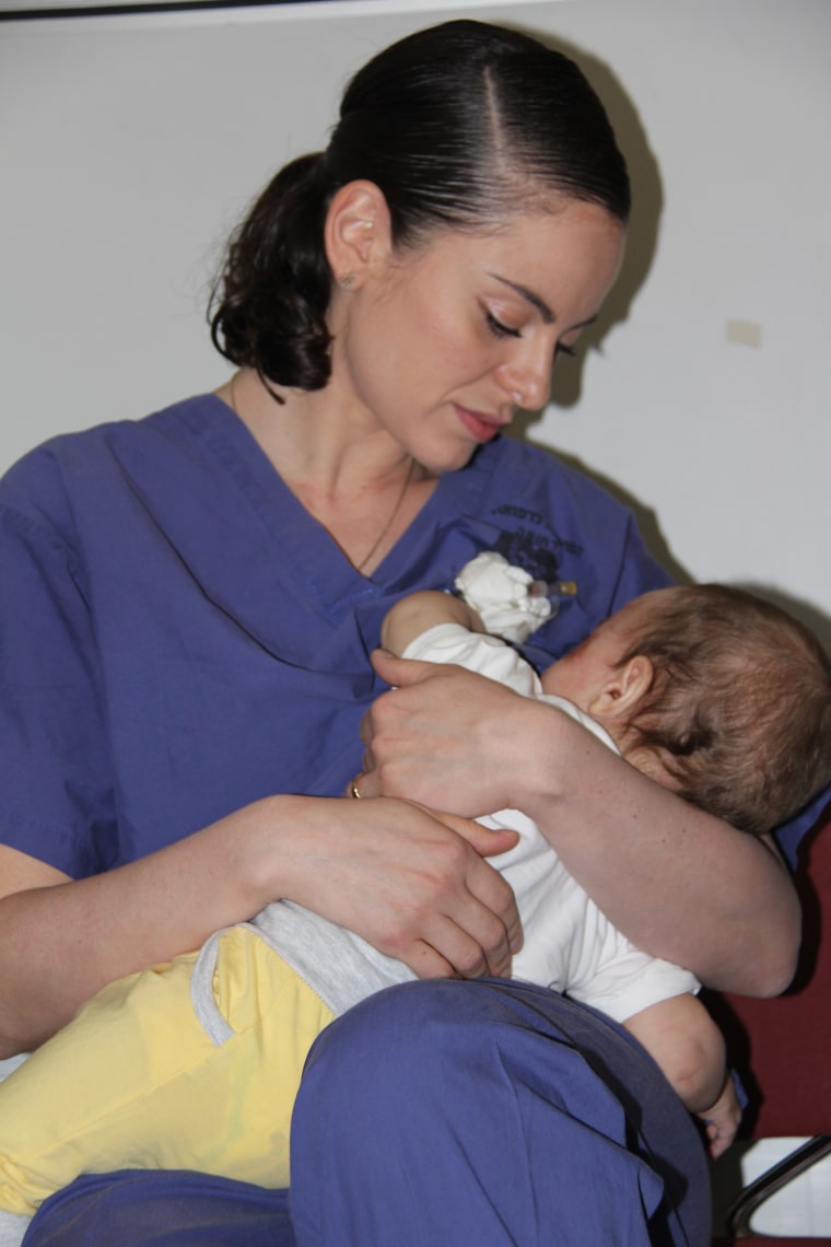 Nurse Ola Ostrowski-Zak with 9-month-old Yamen, whose parents were in a horrific car accident.