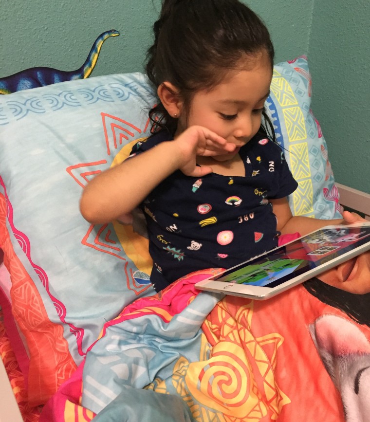 Mirna Pedraza's daughter, Mili, 3, playing a game on her tablet.