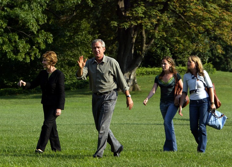 President George W. Bush and first lady Laura Bush walk with their twin daughters Jenna and Barbara Bush on the South Lawn of the White House in 2004.