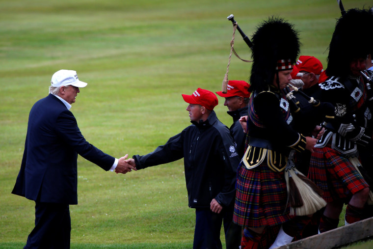 Image: Donald Trump shakes hands with a supporter after getting off his helicopter at Turnberry Golf course