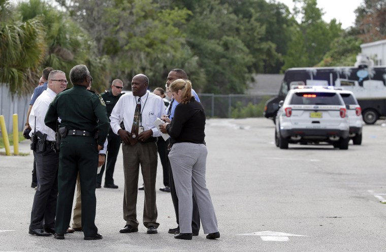 Image: Authorities confer, June 5, 2017, near Orlando, Florida. Law enforcement authorities said there were \"multiple fatalities\" following a Monday morning shooting in an industrial area near Orlando.