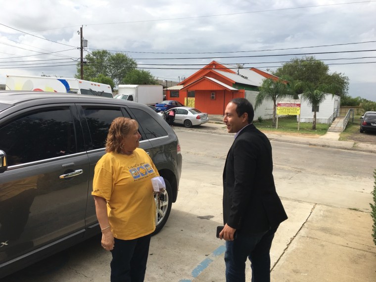 Mayor Reyes visits with a city resident El Cenizo, Texas.