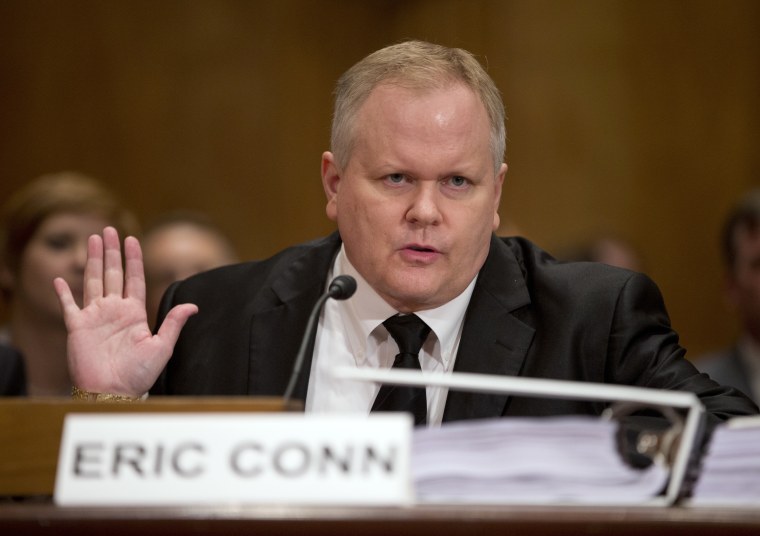 Image: Attorney Eric Conn gestures as he invokes his Fifth Amendment rights against self-incrimination during a Senate Homeland Security and Governmental Affairs committee hearing on Capitol Hill in Washington, Oct. 7, 2013.