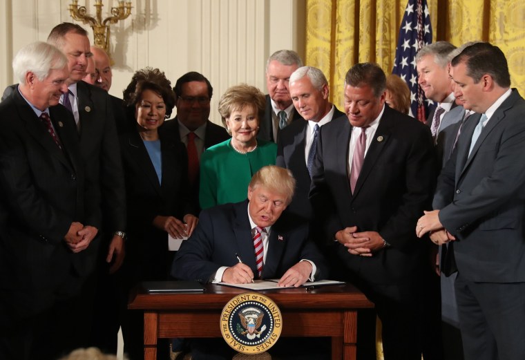 Image: President Donald Trump signs a decision memo and a letter to members of Congress outlining the principles of his plan to privatize the nation's air traffic control system