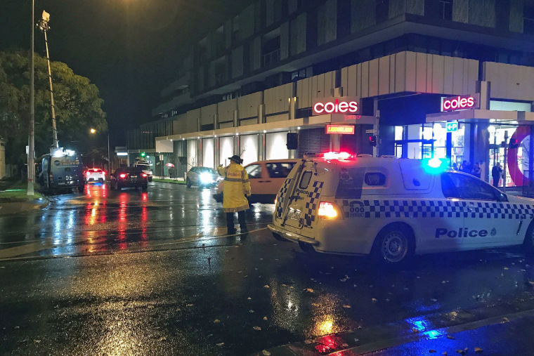 Image: Police and emergency services stand near the scene of a hostage situation in Melbourne, Australia