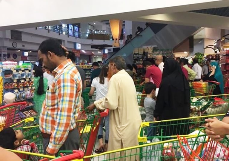 Image: People are seen buying essential food staples in Doha