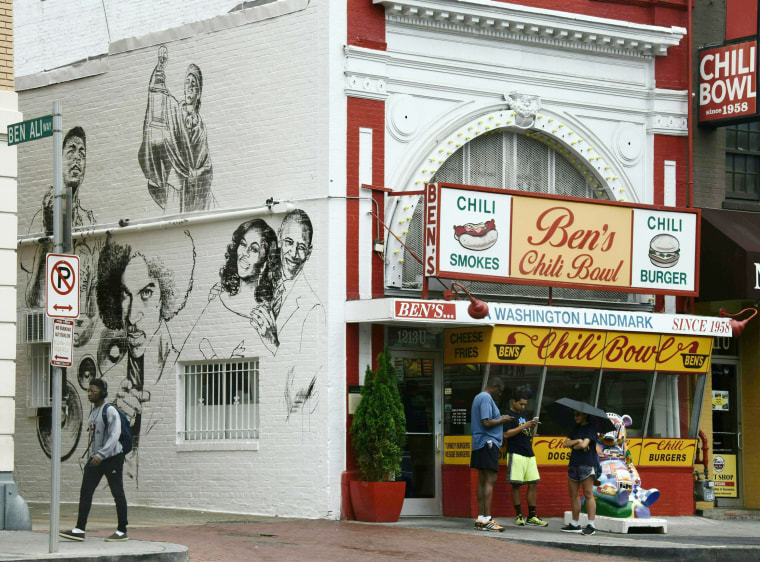 Image: Pedestrians walk past the new mural at Ben's Chili Bowl