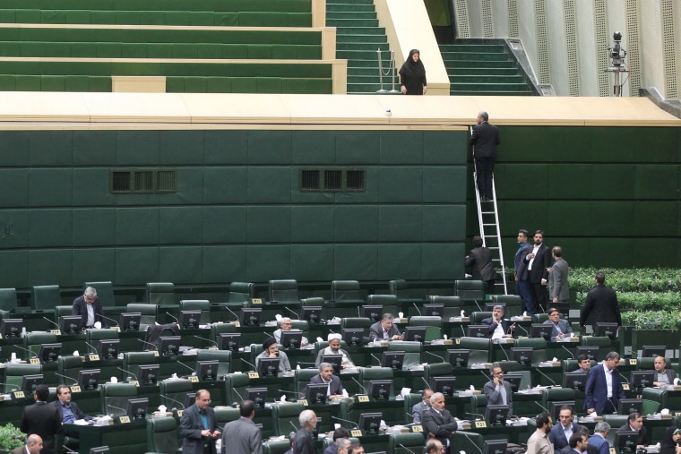 Image: Iranian lawmakers sit inside the parliament during an attack in central Tehran