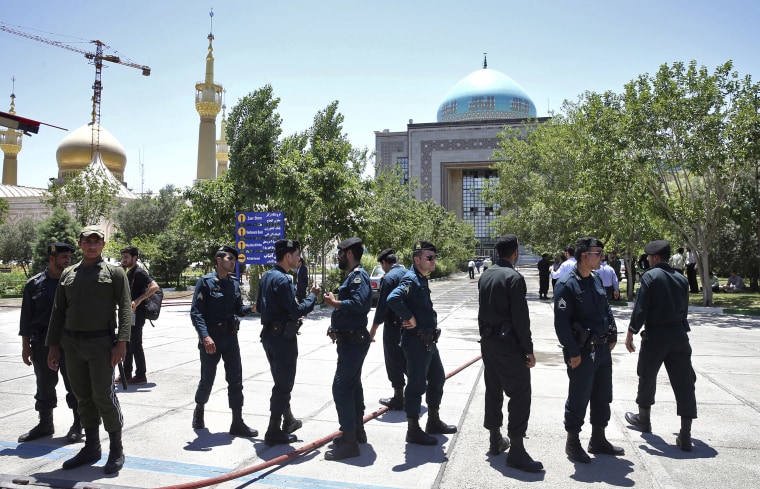 Image: Police officers control the scene outside the shrine of late Iranian revolutionary founder Ayatollah Khomeini