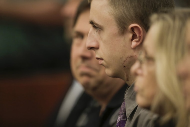 Image: Micah Fletcher sits in court as Jeremy Christian shouts during a court appearance