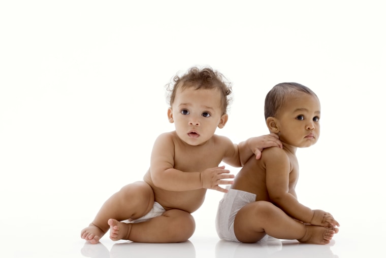 Image: Two baby boys (6-11 months) sitting on white background