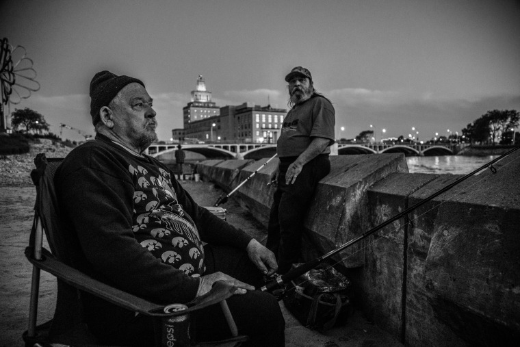 Image: Brothers Tom (right) and Gary (left)-- who declined to give their real names-- fish along the river.
