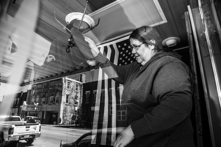 Image: Cindy Brennaman tidies her shop in Anamosa. \"I think he's a piece of crap,\" she said.