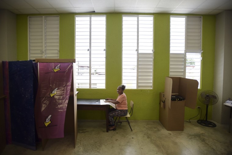 Puerto Rican resident Maria Quinones votes during the fifth referendum on the island's status, in San Juan, Puerto Rico, Sunday, June 11, 2017.