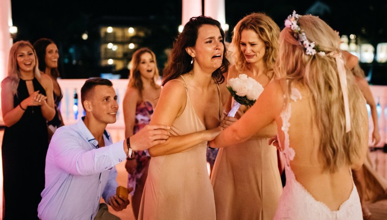 From left, Adam Brake prepares to prose to Jessica Kieley as Meaghan Lee and bride Jess Nakrayko look on. The bride, Lee and Brake arranged the surprise. 