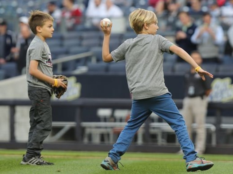 Alex, throwing out a pitch during a Yankees game last month, said making people laugh as a fundraiser is easy. "You can bring jokes with you anywhere."
