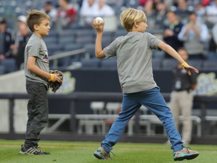 Alex, throwing out a pitch during a Yankees game last month, said making people laugh as a fundraiser is easy. "You can bring jokes with you anywhere."
