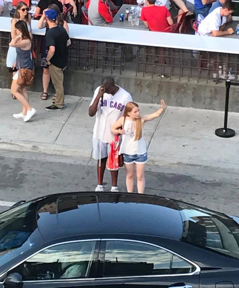 Chicago resident Ryan Hamilton captured a heartwarming moment between strangers at Wrigley Field on June 3.