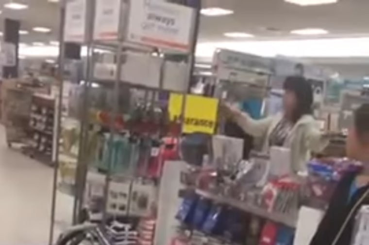 A still taken from a video recorded by Simoni Lovano showing a woman berating a family and cashier using racially-tinged language.