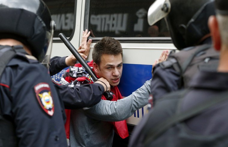 Image: Russian police officers detain a participant of an unauthorized opposition rally