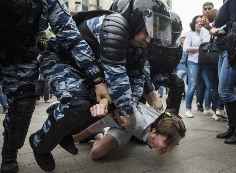 Image: Police detain a protester in Moscow