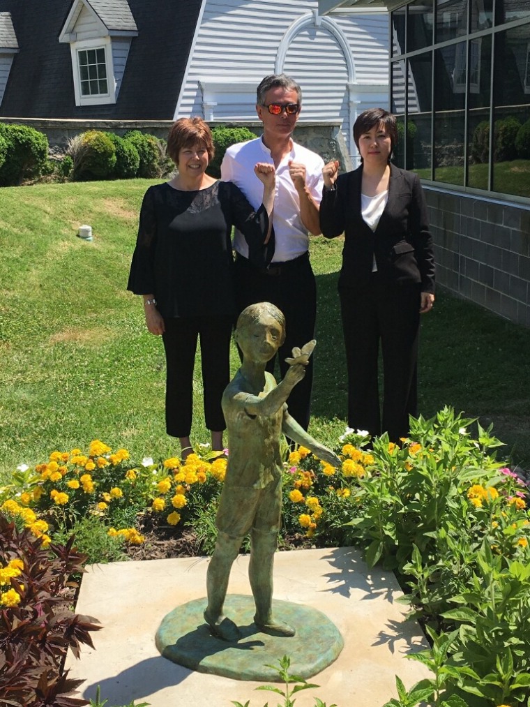 Nancy Cho Auvil (l.), vice president of Hyunsu Legacy of Hope; Thomas Park Clement; and Nanleigh Yi, president of Hyunsu Legacy of Hope, at Monday's unveiling of "Hyunsu's Butterfly" in Maryland.