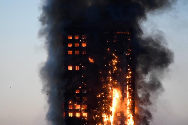 Image: Flames and smoke billow as firefighters deal with a serious fire in a tower block at Latimer Road in West London