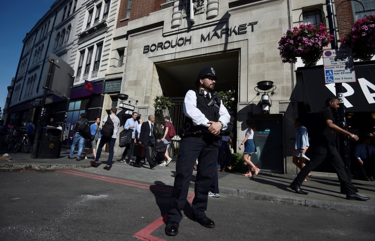 Image: A police officer stands in front of an entrance to Borough Market