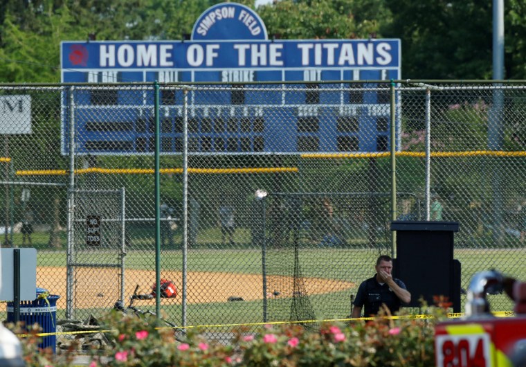 Image: Police investigate a shooting scene after a gunman opened fire on Republican members of Congress during a baseball practice in Alexandria, Virginia