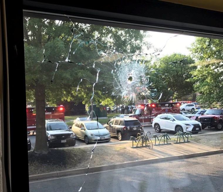 Image: A bullet hole is seen in a window after a gunman opened fire on Republican members of Congress during a baseball practice near Washington in Alexandria Virginia