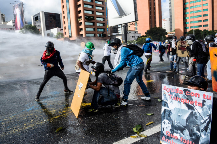 Image: Opposition activists use makeshift shields as they clash with the police during the "Towards Victory" protest against the government of President Nicolas Maduro in Caracas on June 10, 2017.