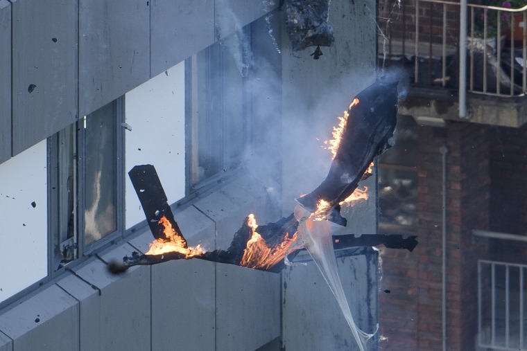 Image: Burning debris falls off Grenfell Tower 