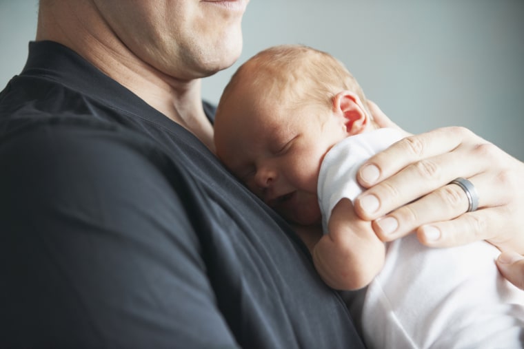 Image: father holding newborn