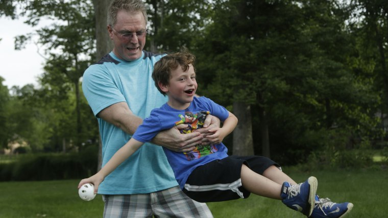 Dean Cravens makes sure his 5-year-old neighbor Brian Kelly is having fun while Brian's dad is overseas.