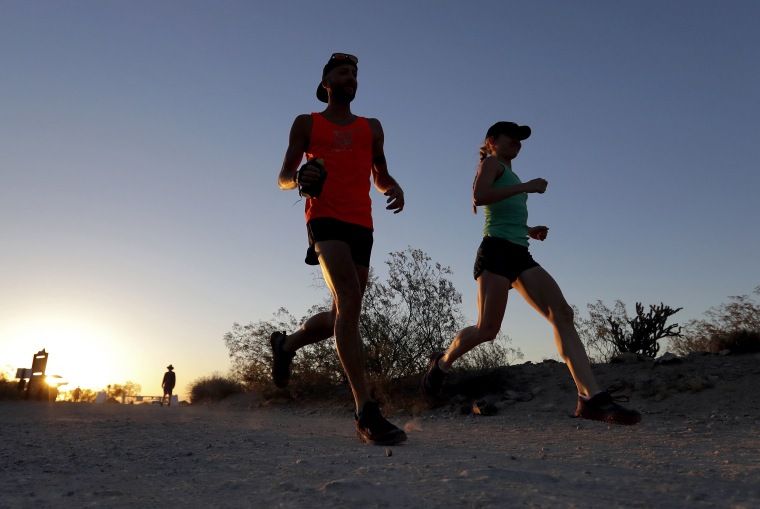 Image: A couple runs through section of South Mountain Park in Phoenix