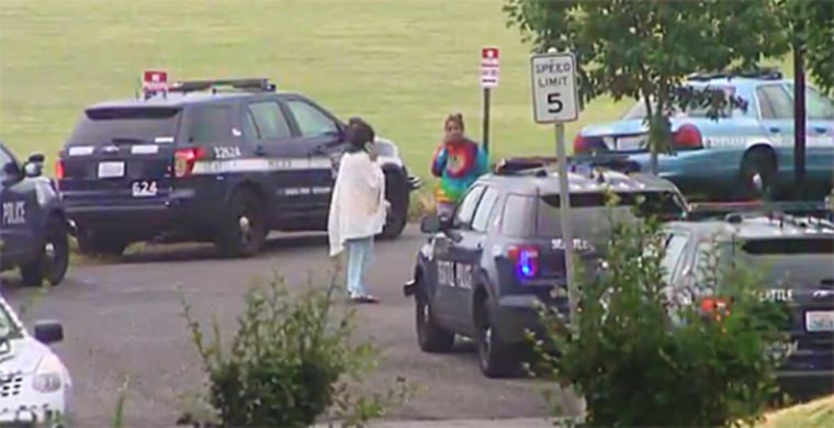 Seattle police respond at the scene where police earlier shot and killed a woman while responding to a burglary call.