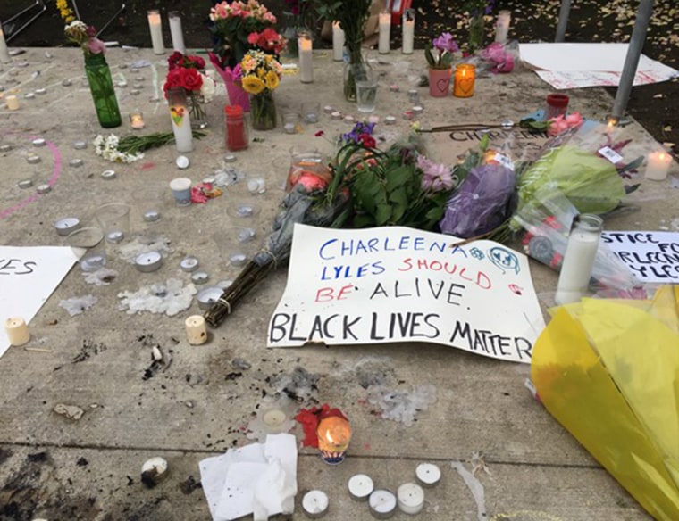 Candles and flowers form an impromptu memorial to Charleena Lyles in Seattle.