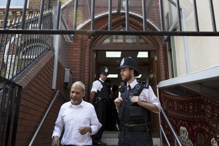 Image: Met Police officers guard the entrance of the Finsbury Park mosque in north London