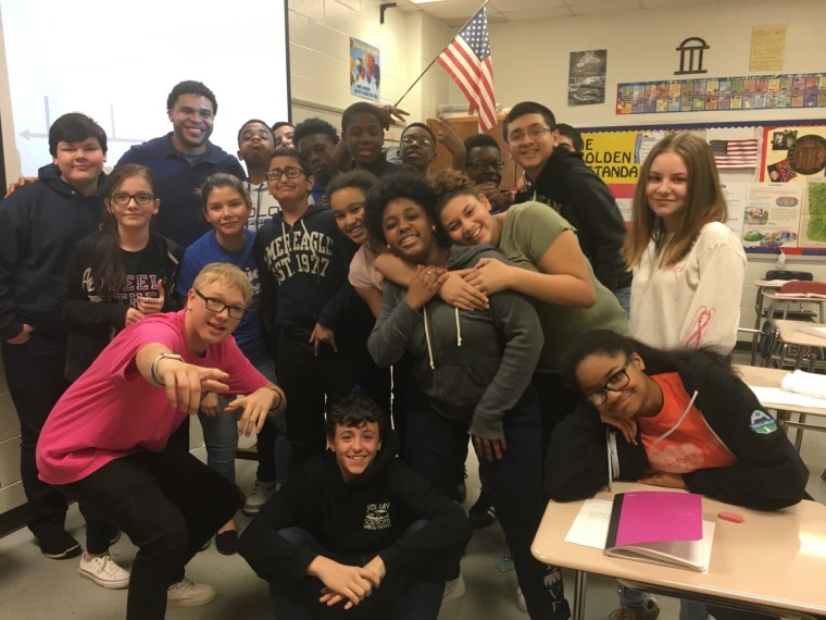 Image: David Yancey with his 8th grade students at Edwards Middle School