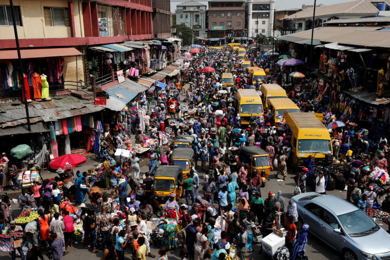 Image: People crowd a street at the central business district in Nigeria's commercial capital Lagos ahead of Christmas