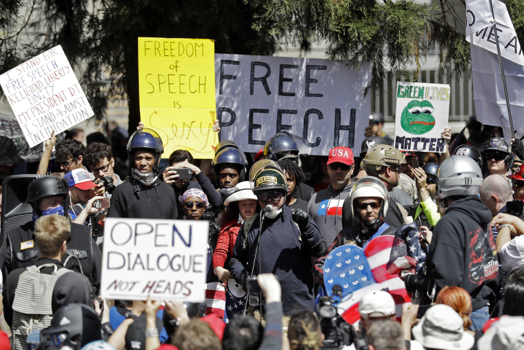 Image: A crowd gathers around speakers during a rally for free speech