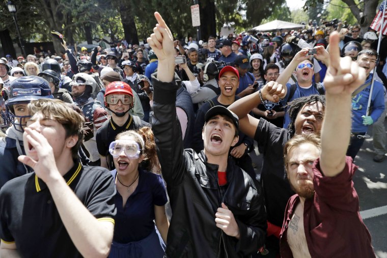 Image: A crowd gathers around speakers during a rally for free speech