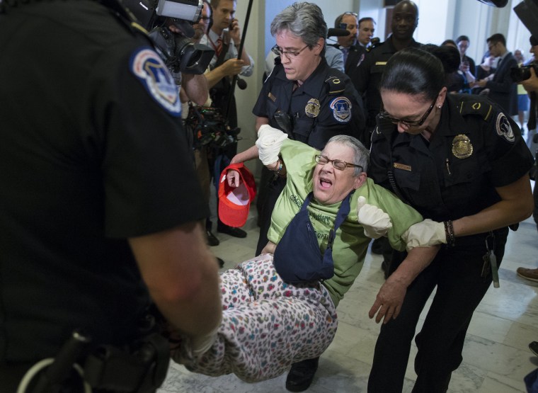 Image: U.S. Capitol Police carry away a protester