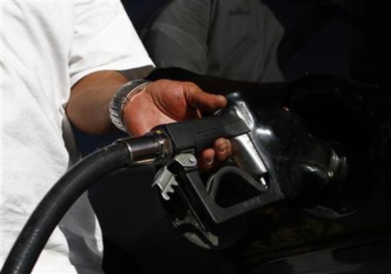 A motorist pumps fuel into his vehicle at JJ's Express Gas Plus station in Phoenix gas station in Phoenix