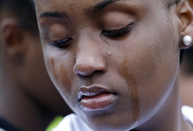 Image: A woman cries at a vigil