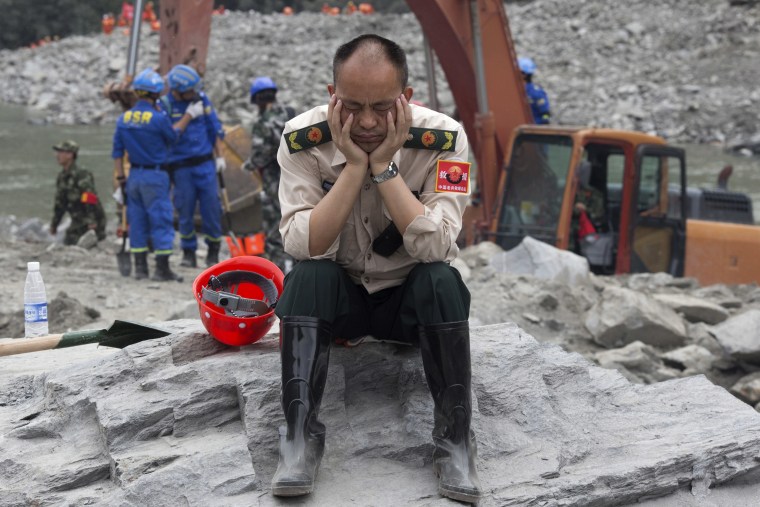 Image: A rescue worker takes a nap on June 25.