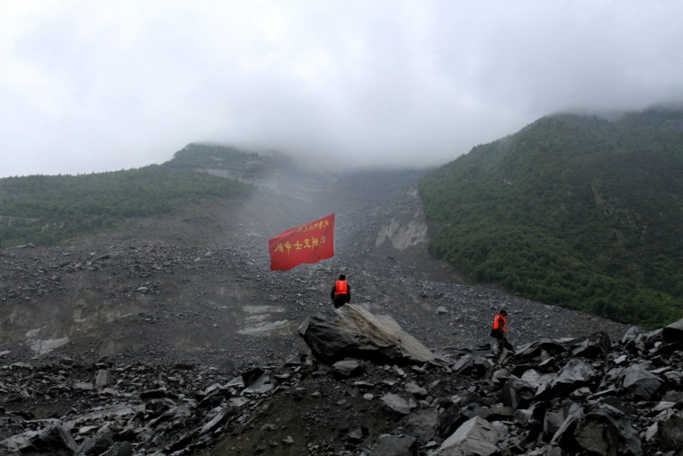 Image: Dusk falls over the site of the landslide on June 24.