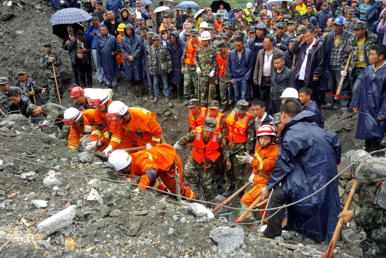 Image: Rescue workers search for survivors on June 24.