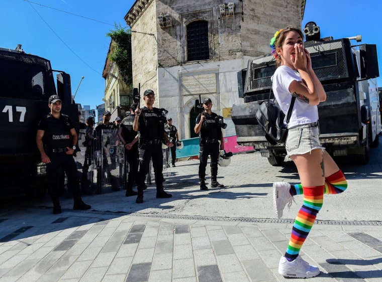 Image: Riot police block the way to Istikjlal avenue for an LGBT rights activist as they try to gather for a pride parade, which was cancelled in Istanbul,