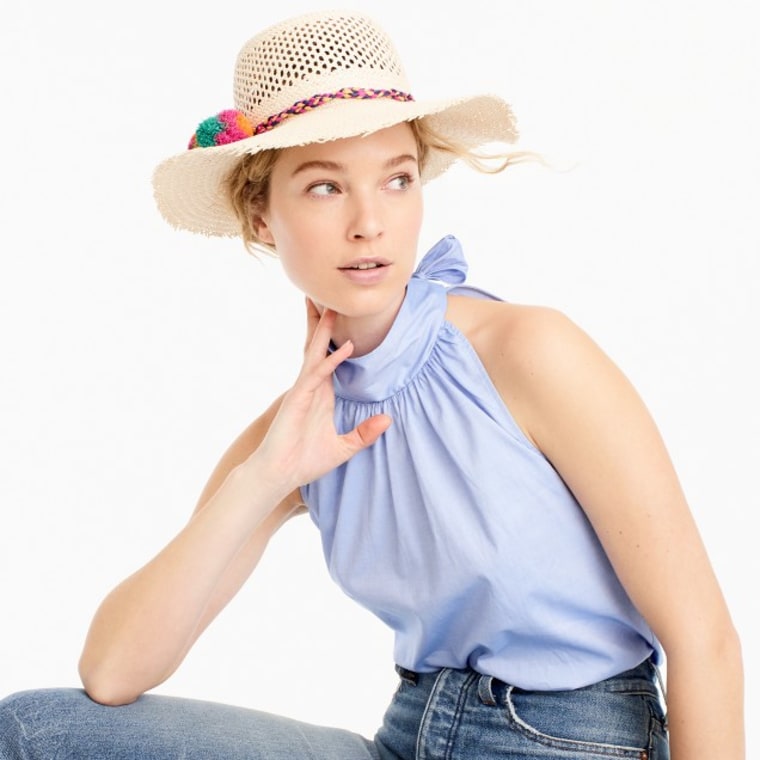 Straw hat with rainbow pom-poms